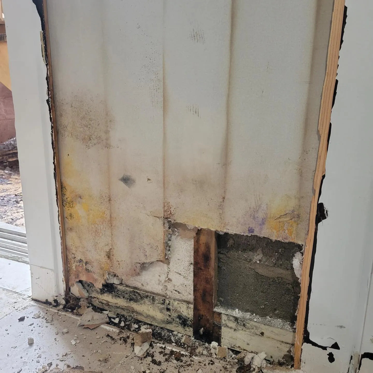 Water-damaged flooring and subfloor being removed during restoration cleanup and assessment